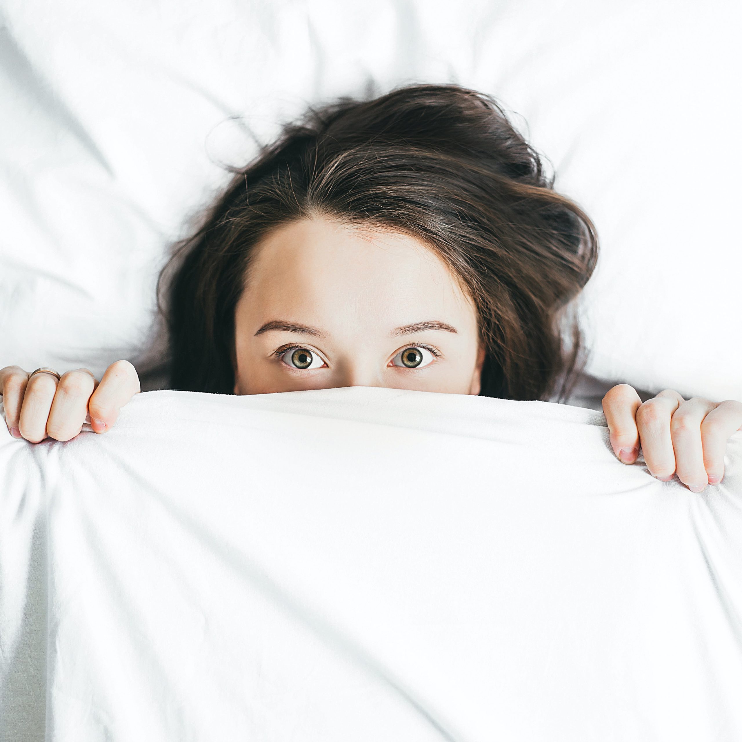 A person sleeping peacefully in a bed
